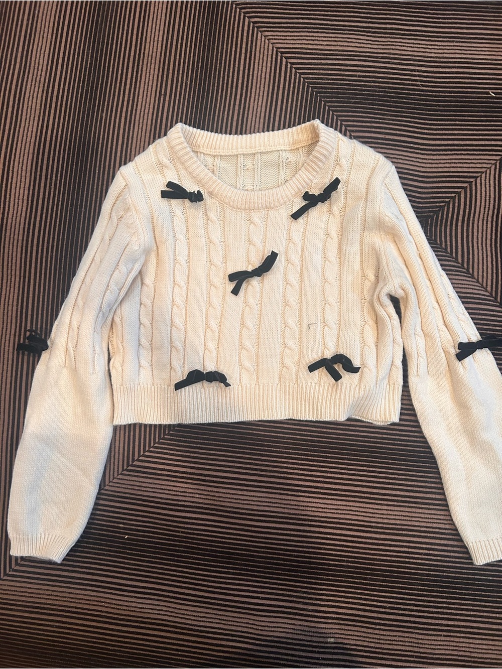Cream Cable-Knit Sweater with Black Bow Accents